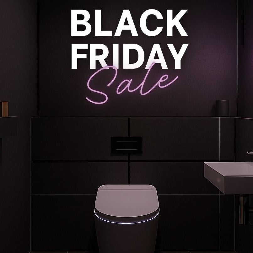 Bathroom with black tiles, a toilet, sink, and neon signs advertising 'Black Friday Sale' and 'TUDALOO'.